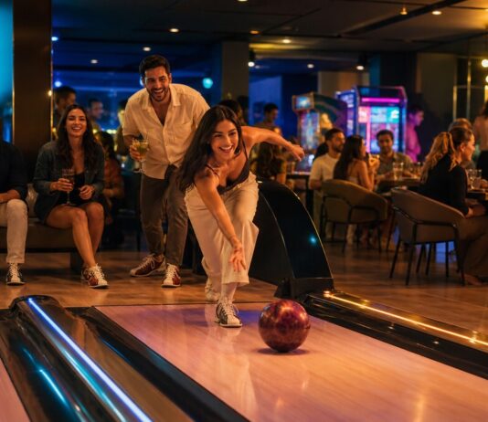 Brass Monkey Abu Dhabi Opens This September Adults enjoying bowling, arcade games and dining at an Abu Dhabi venue