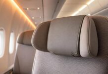 Emirates Cushioned Headrest: Economy Upgrade Premium aircraft economy seat with cushioned adjustable headrest detail