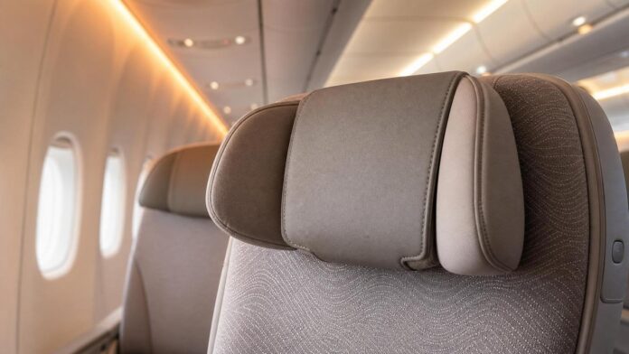 Emirates cushioned headrest economy upgrade featured image Premium aircraft economy seat with cushioned adjustable headrest detail