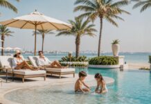 Four Seasons Dubai Daycation: Family Pool Day Family enjoying a calm beachfront resort pool day in Dubai
